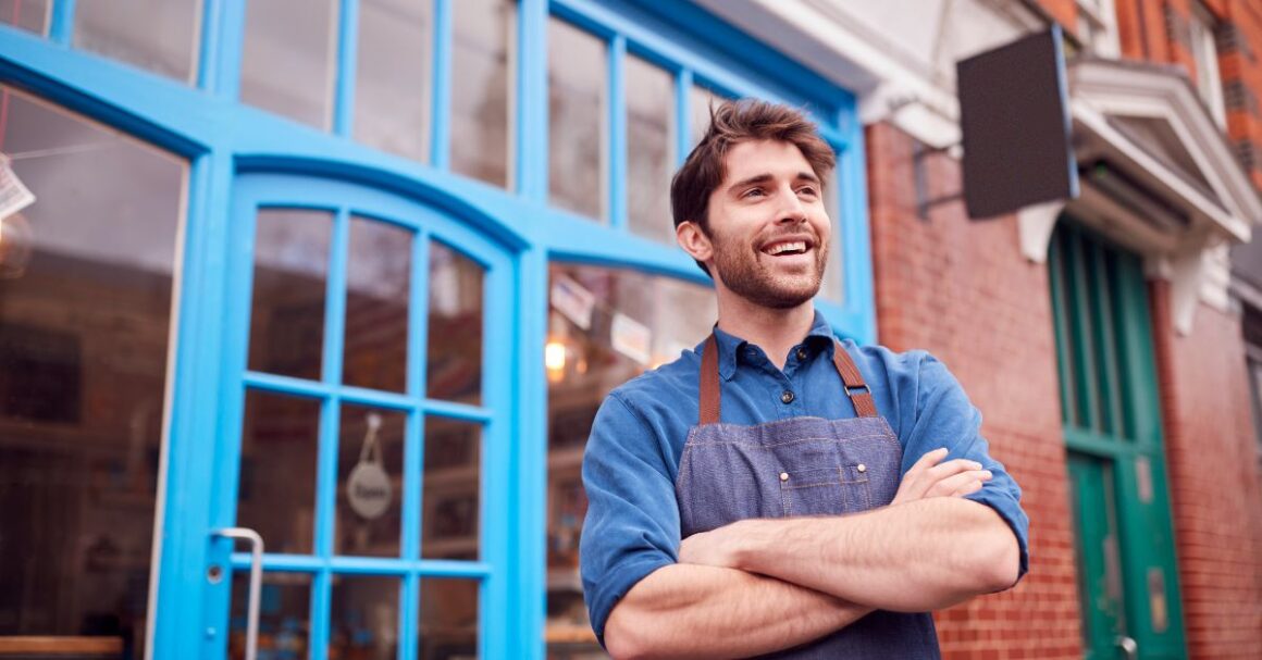 smilingmanstandsoutsidebluestorefrontwithar20260922181326utc 1 ND Professional Services